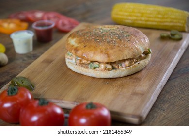 burger style chicken pizza chunk sandwich filled with tikka and fajita chunks and cheese