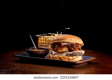 burger surf and turf com burger with melted beef cheddar shrimp with cheddar sauce black background - Powered by Shutterstock