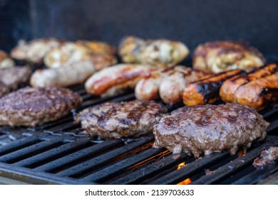 Burgers And Sausages Grilling On A BBQ