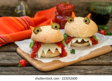 Burgers in the shape of devil with cheese, tomato sauce. Shallow depth of field. Selective focus - Shutterstock ID 223252600