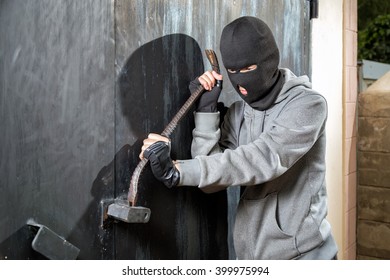 A Burglar Breaking Open Of A Padlock Metal Door