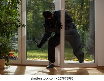 Burglar entering to house trough balcony window
