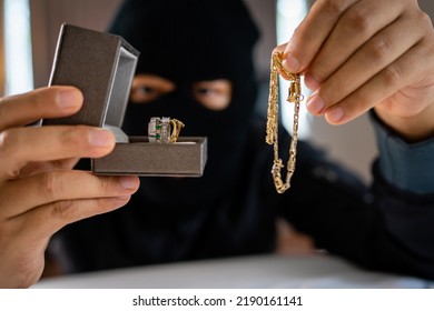 Burglar Holding Jewelry Indoor. Robbery Concept.