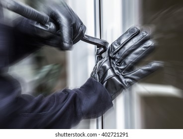 A Burglar Opens A Window