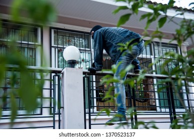 Burglar Robbery Or Burglary. Climbing The House