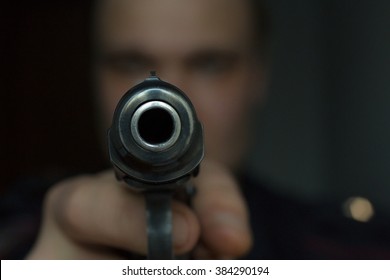 burglar or terrorist in black mask shooting with gun black