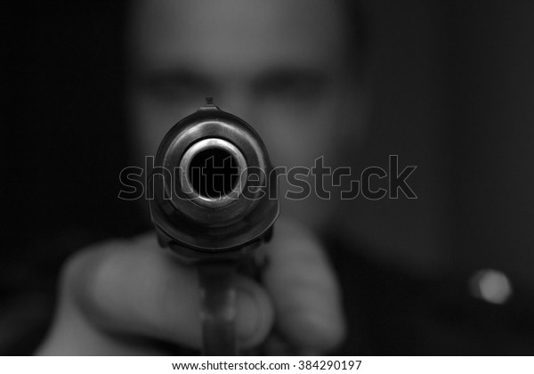 burglar or terrorist in black mask shooting with\
gun black