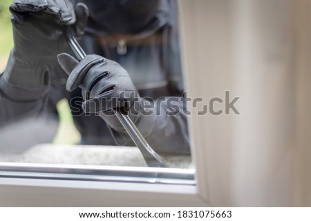 Burglar tries to break in through a window