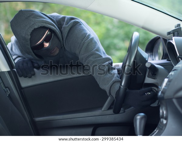 Burglar wearing\
mask balaclava stealing car\
key