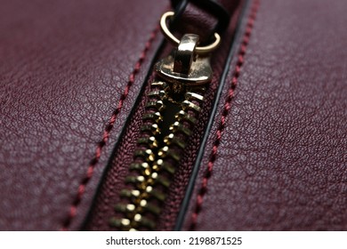 Burgundy Leather Fabric With Zipper As Background, Closeup