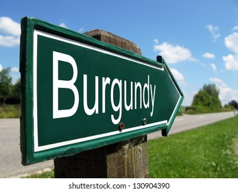 Burgundy signpost along a rural road