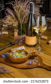 Burgundy Snails With Green Butter And Cheese, Gourmet Dish, In Traditional Ceramic Pans With Bread And Glass Of White Wine On A Wooden Table