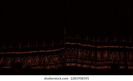 Burgundy theater curtain with gold embroidery in the dark hall before the performance in the theater - Shutterstock ID 2281958195