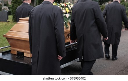 A Burial Process With A Coffin To The Grave