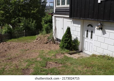 Buried Ground Soil Dirt Sand Grass Lawn Site Area In The Garden Outside The White Brick House With Closed Shed And Door Exterior And Estate