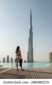 Burj Khalifa View From Skyview Downtown, Lady On An Infinity Pool Looking At The Tallest Building In The World. Dubai, UAE 25-06-2021