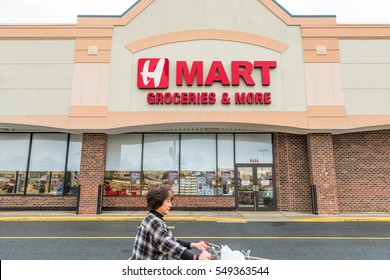 Burke, USA - November 30, 2016: Hmart Asian Grocery Store Facade And Sign With Korean Woman And Shopping Cart