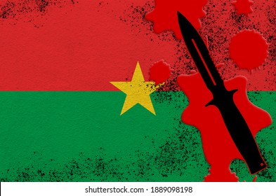 Burkina Faso Flag And Black Tactical Knife In Red Blood. Concept For Terror Attack Or Military Operations With Lethal Outcome. Dangerous Melee Weapon Usage