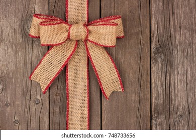 Burlap Christmas Bow And Ribbon Side Border, Above View On A Rustic Wood Background