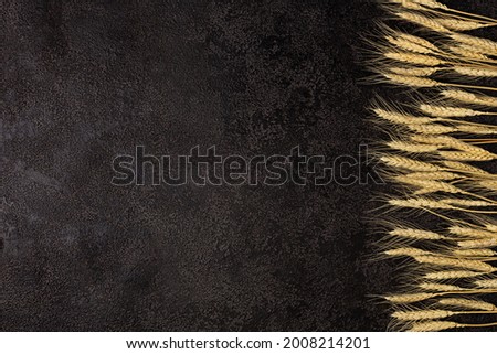 Burlap napkin on a dark structural background, top view. Ears of wheat. Copyspace. top view