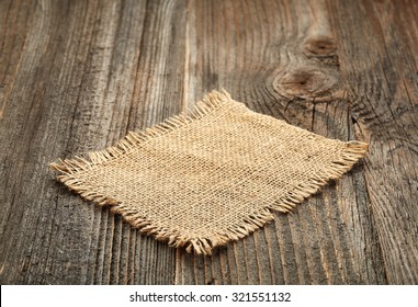 Burlap Napkin On Old Wooden Table