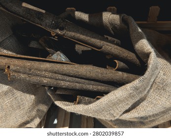 Burlap sack filled with rustic cinnamon sticks in warm earthy tones