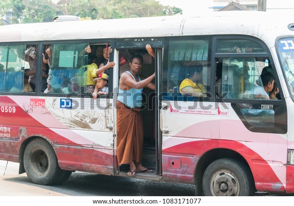 Burmese man standing on the crowded\
bus.Photo taken at Yangon,Myanmar.Date : April\
16,2018.