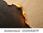 Burn black paper with fire damaged on beige background for your presentation