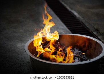 Burn paper, gold paper meaning sent money and gold to Deceased predecessor In New Year Chinese in basin on cement floor / Blurred and Select focus - Shutterstock ID 1303553821