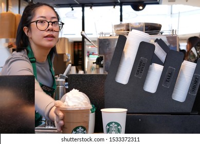 Burnaby, BC, Canada - March 26, 2019 : Motion Of Barista Making Coffee For Customer At Starbucks Store