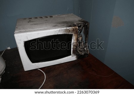 burnded and damged white microwave