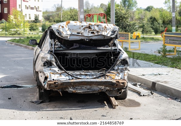 Burned and broken car. War in\
Ukraine 2022. Russian missiles in Kharkiv Ukraine. Russian\
aggression, conflict. Russian attack on Ukraine. Russia is bombing\
Ukraine