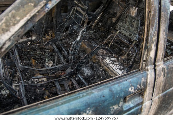 Burned car, burned-out car body. Machine after\
a fire close up. Protests with the burning of cars of citizens. Car\
insurance.