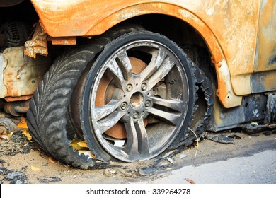 Burned Car In The Car Park: Broken Wheel