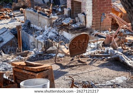 a burned chair at a home destroyed in the Altadena wildfires in Altadena California USA