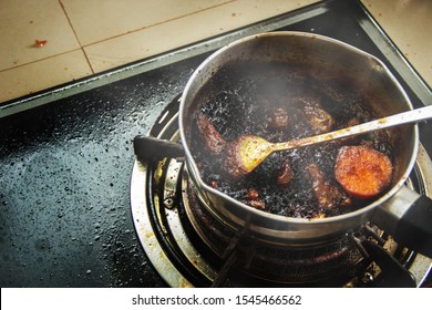 Burned Food In The Pot On A Gas Stove And Full Of Oil Stains From Warming Up Food That Is Forgetful.