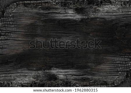 Burned noisy scratched hardwood surface. BBQ background. Burnt wooden Board texture.  Smoking wood plank background. Burned wooden grunge texture. 