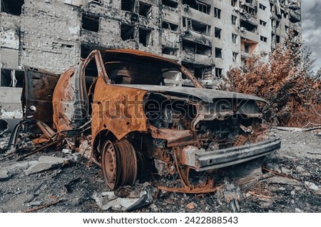 burned out blown up car against the background of a destroyed house war between Russia and Ukraine
