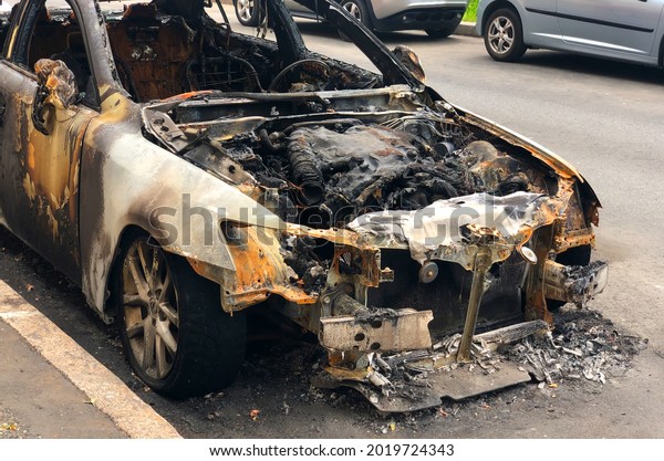 Burned out car on the\
side of the road