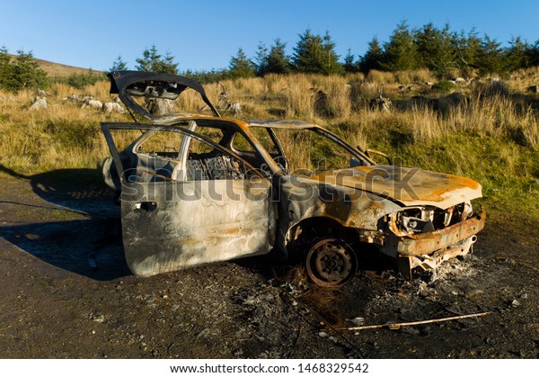 Burned out car\
wreck in the nature of\
Ireland