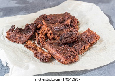 Burned Pie (chocolate Cake) On Baking Paper. Failed Food. Unsuccessful Failure Cooking In Kitchen. Disappointment, Spoiled Food.