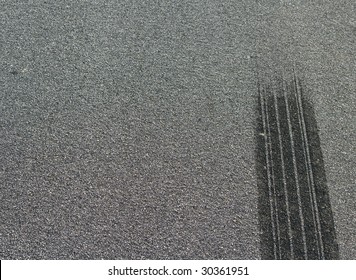 A Burned Rubber Tire Track On An Asphalt Road.