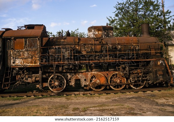Burned-out locomotive is a museum\
exhibit at the railway station in the city of Trostyanets. Sumy\
region. Civil buildings. Russian military invasion of\
Ukraine