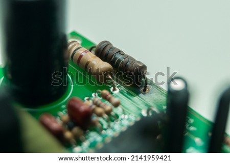 A burned-out resistor on an electronic circuit board. A high-temperature damaged part of an electronic device. Electronics repair. Selective focus