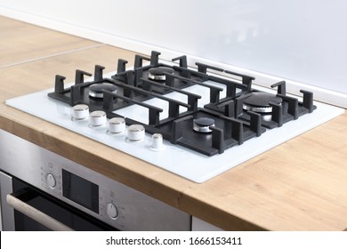 Burners on a white glass gas cooker in the kitchen. View from above. - Shutterstock ID 1666153411