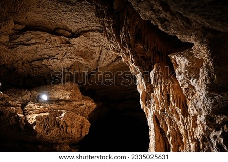 BURNET, TEXASUSA - JULY 3rd 2023: a family with a teenage girl on a road trip during school summer holidays, visiting Longhorn Cavern State Park with its intricate paths and natural stone works.