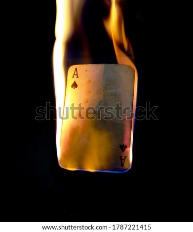 Burning Ace of spades. Ace has the highest card value in a deck of card and the fire depicts it's power and superiority.
The picture can be used for background or wallpaper or logo making.