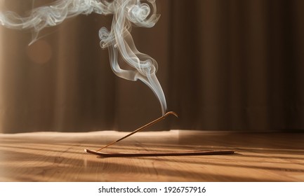 Burning aromatic incense smoky stick for meditation and relaxing. Aromatherapy smoke for yoga concept. - Powered by Shutterstock