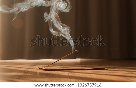 Burning aromatic incense smoky stick for meditation and relaxing. Aromatherapy smoke for yoga concept.