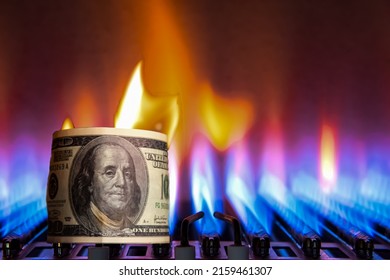 Burning Banknote on the background of a gas burner. Cash. High prices for natural resources. Tongues of flame. Public debt. Energy war.Out of focus.